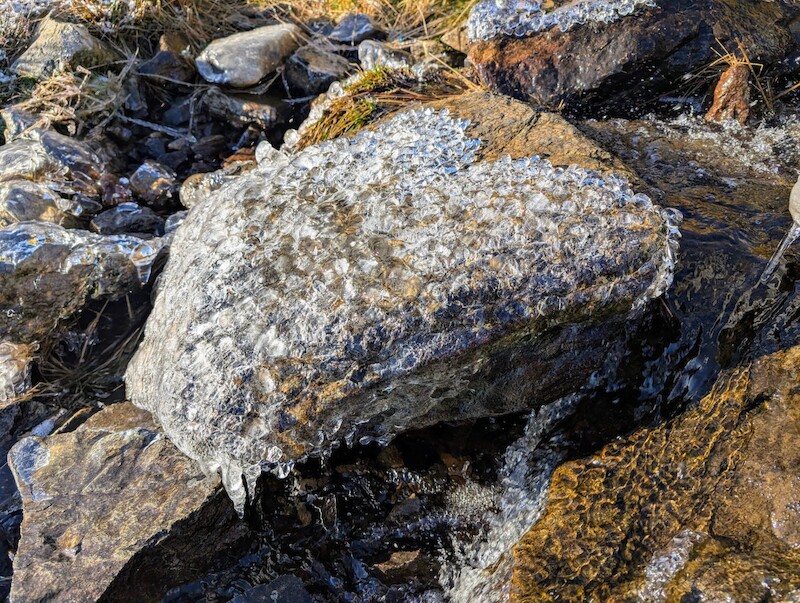 Water was running under the ice on this stone in a beck - © Copyright 2025 Peter Burlingham, Days In The Lakes