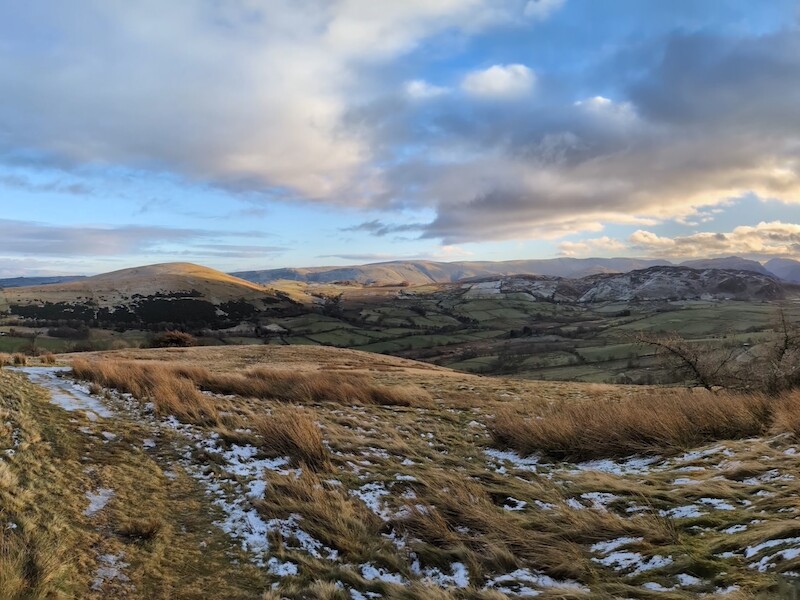 From the summit with Little Mell Fell on the left and you can see the fells on the far side of Ullswater to the right of that - © Copyright 2025 Peter Burlingham, Days In The Lakes