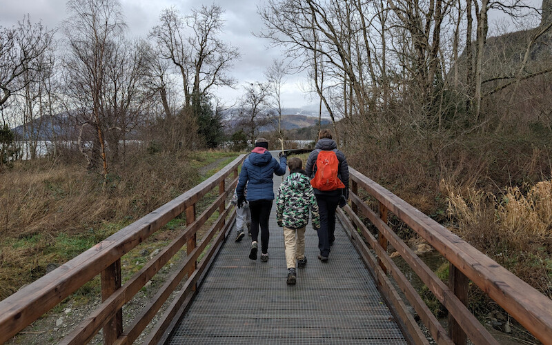 Mum, Millie, Sam and James on the boardwalk by the lake - Millie also has a stick! - © Copyright 2025 Peter Burlingham, Days In The Lakes