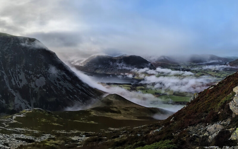 A stunning view across Crummock Water to Mellbreak on the far side - the cloud rolling down Grasmoor on the left of the photo - © Copyright 2025 Peter Burlingham, Days In The Lakes