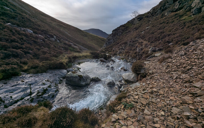 The path along the beck is badly eroded in places but still walkable - © Copyright 2025 Peter Burlingham, Days In The Lakes