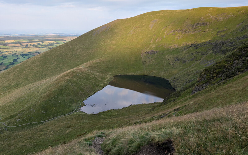 As you start your descent you get a view back towards where you've been earlier - © Copyright 2025 Peter Burlingham, Days In The Lakes