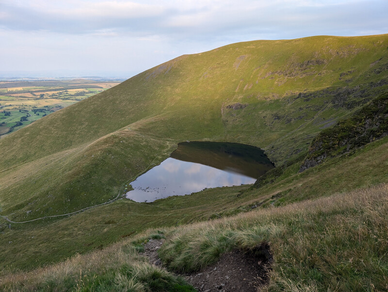 As you start your descent you get a view back towards where you've been earlier - © Copyright 2025 Peter Burlingham, Days In The Lakes