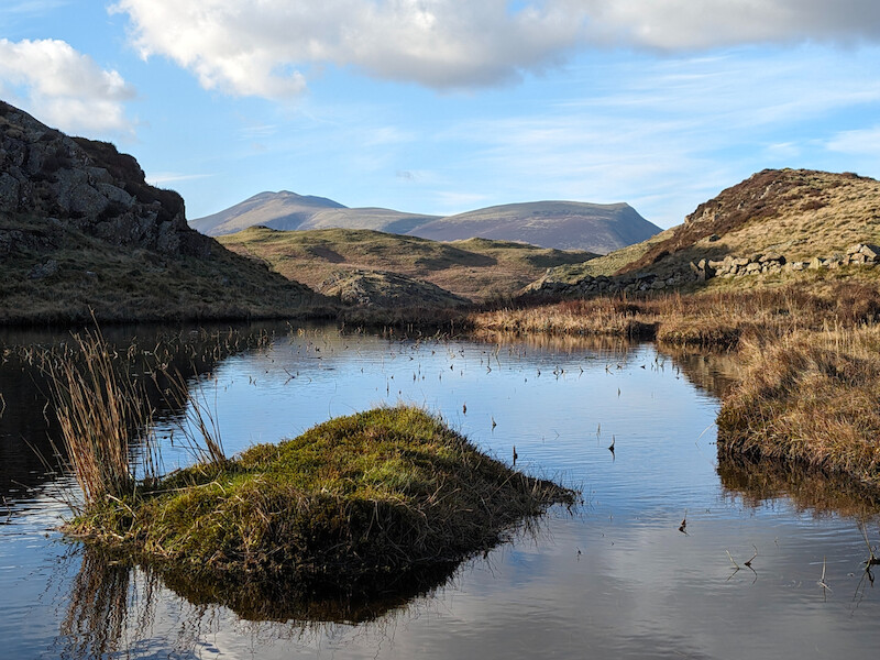 A view back towards Skiddaw (L) and Lonscale Fell (R) from the tarn - © Copyright 2025 Peter Burlingham, Days In The Lakes